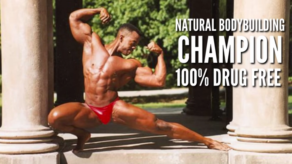 Natural Bodybuilding Champion Kevin Richardson posing outdoors showing his built shoulders