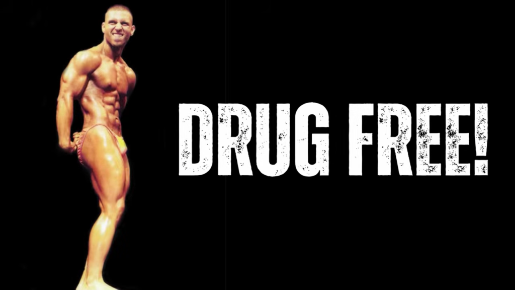 A natural bodybuilder poses onstage as Kevin explains that a moderate calorie and protein intake can still help you reach a professional level in bodybuilding